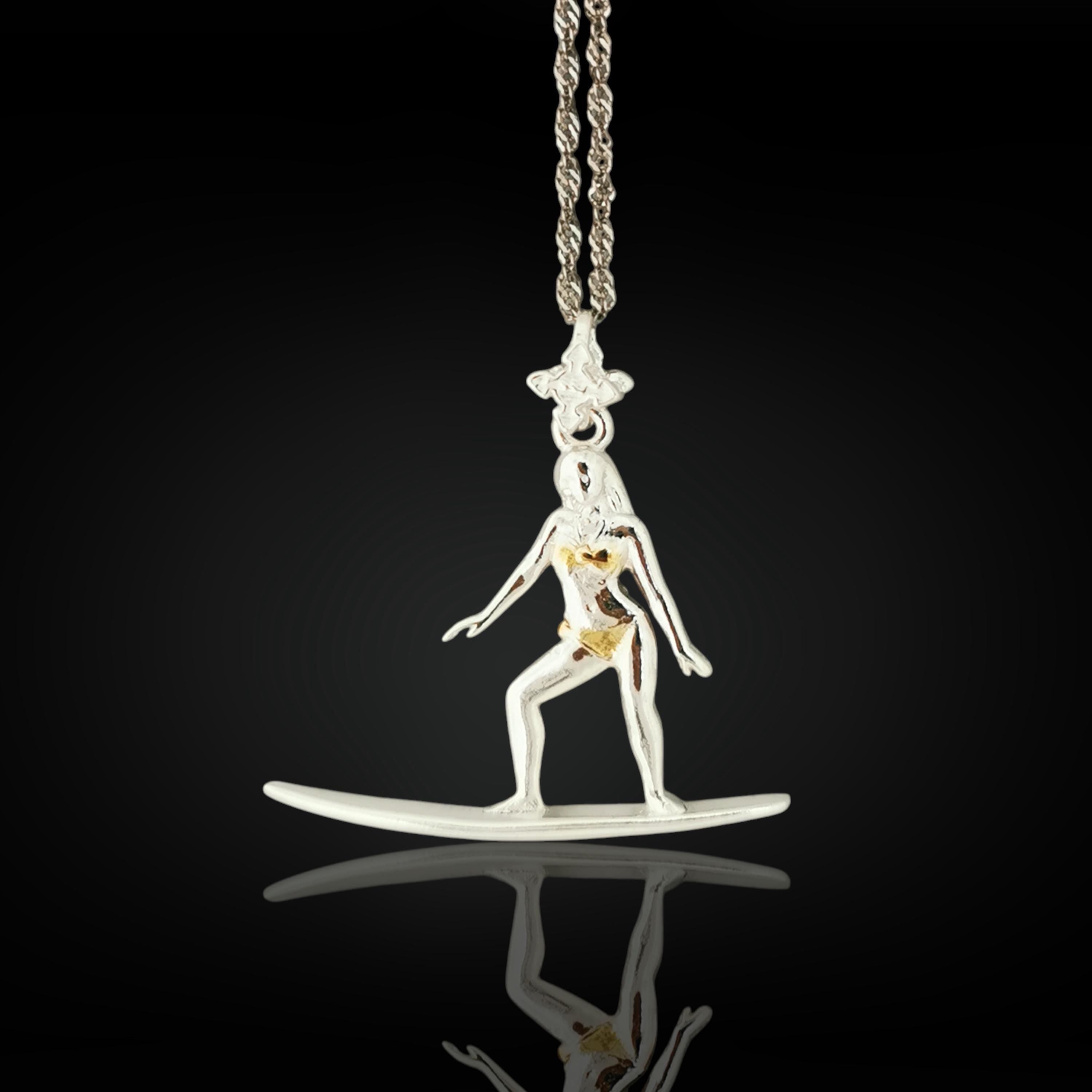 Gold-plated surf girl necklace handcrafted from solid 925 sterling silver — a radiant pendant celebrating sun-kissed waves, freedom, and feminine spirit.

This design captures a woman in motion atop her surfboard — elegant, balanced, and unstoppable. The polished gold finish brings warmth and coastal glamour, evoking memories of endless summer and ocean serenity. A meaningful gift for those who chase waves and live by the tide.