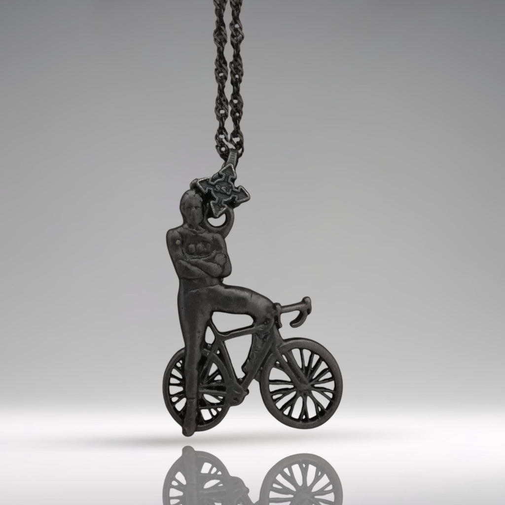 Black oxidized cyclist pendant handcrafted from solid 925 sterling silver — a rugged and masculine design for men who live with purpose, strength, and motion.

Featuring a confident rider standing beside his bike, arms crossed in pride, this piece embodies discipline, endurance, and an unshakable mindset. The matte oxidized black finish adds edge and intensity, making it a striking accessory for urban cyclists, fitness lovers, and bold personalities.