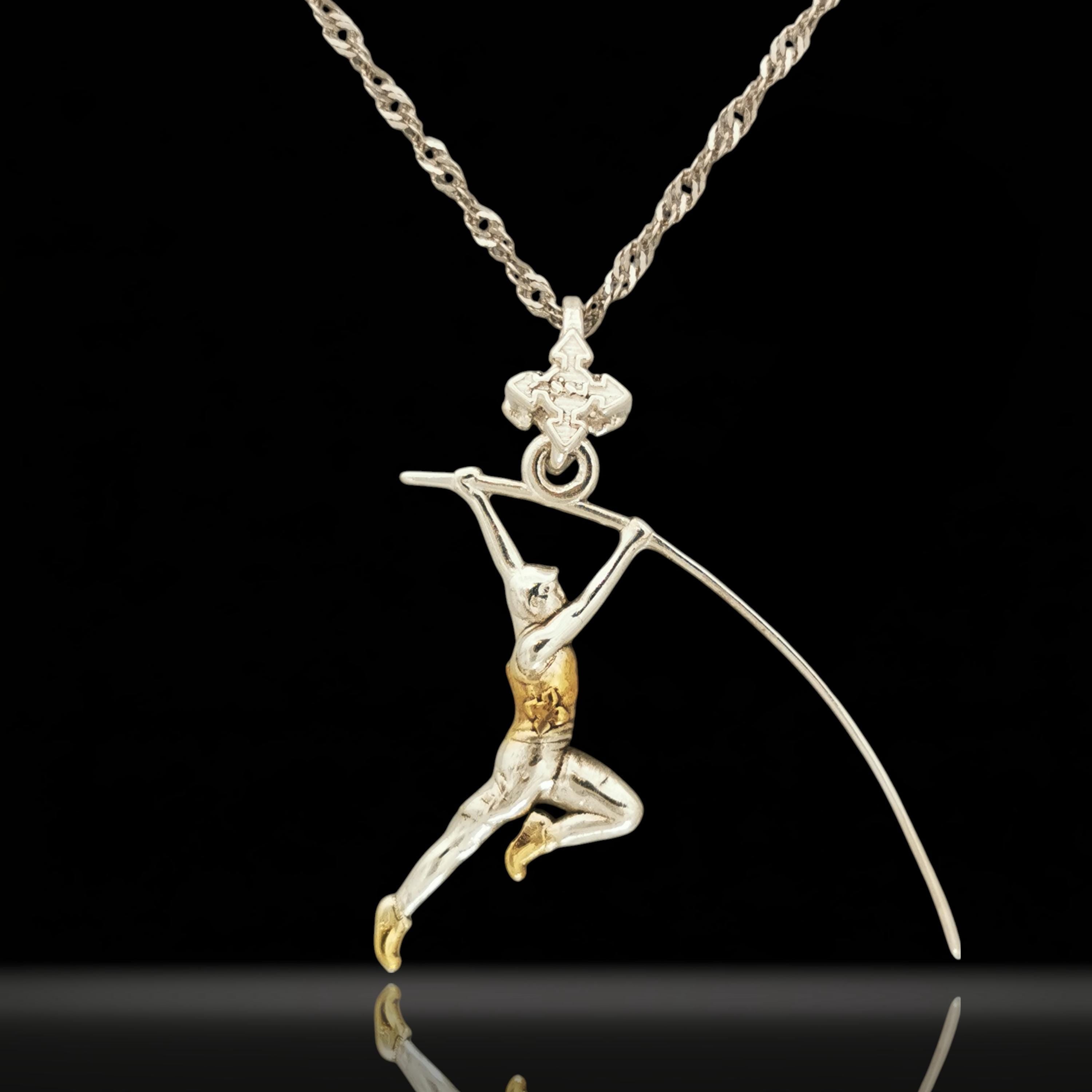 Two-tone pole vault necklace for men — a bold and symbolic pendant honoring strength, elevation, and the relentless pursuit of personal bests.

Handcrafted from solid 925 sterling silver and enhanced with partial gold plating, this dynamic figure captures the explosive motion of a vaulter mid-flight. Designed for athletes who rise above limits and those who live with discipline, energy, and focus.