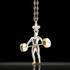 Two-tone weightlifting necklace for men – crafted from solid 925 sterling silver with gold-plated detail. A bold pendant honoring the discipline, strength, and drive of serious athletes.

The design features a muscular figure mid-lift, capturing the explosive energy and control of weight training. The gold accent adds contrast and prestige, perfect for men who train hard and live with purpose.