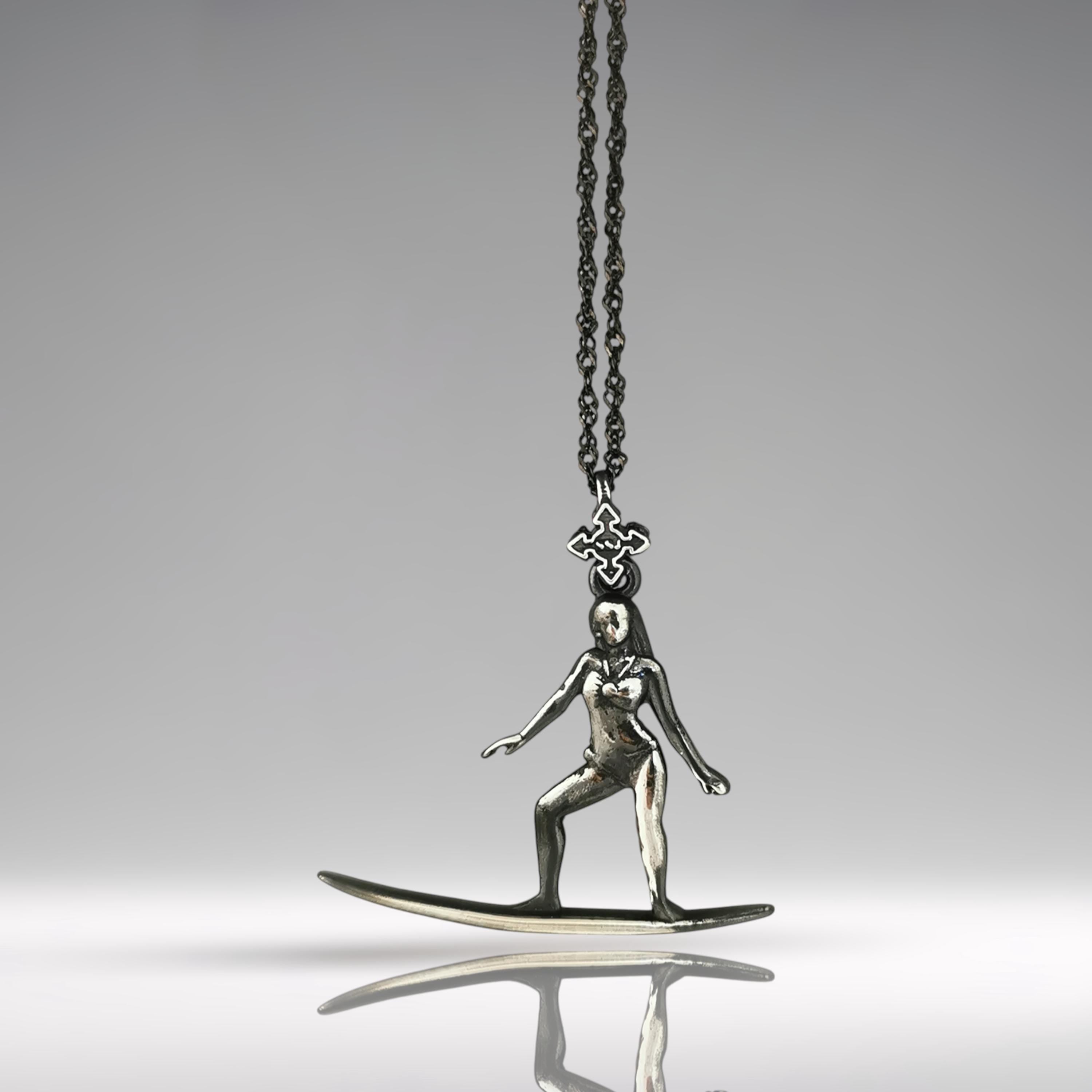 Vintage-style surf girl necklace handcrafted in patinated 925 sterling silver — a soulful pendant capturing the elegance and ease of classic surf culture.

This nostalgic piece features a female surfer mid-ride, her form confident and fluid. The aged silver finish brings retro charm and timeless spirit, making this necklace ideal for women who are connected to the ocean, grounded in movement, and guided by freedom. A wearable story of waves, wind, and wild hearts.
