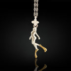 Two-tone diving necklace for women — a symbolic pendant blending silver and gold to honor elegance, strength, and love for the ocean.

This graceful diver design is sculpted in solid 925 sterling silver and accented with radiant partial gold plating. The flowing motion of the figure evokes serenity, movement, and depth — a meaningful piece for those who feel at home in the water.