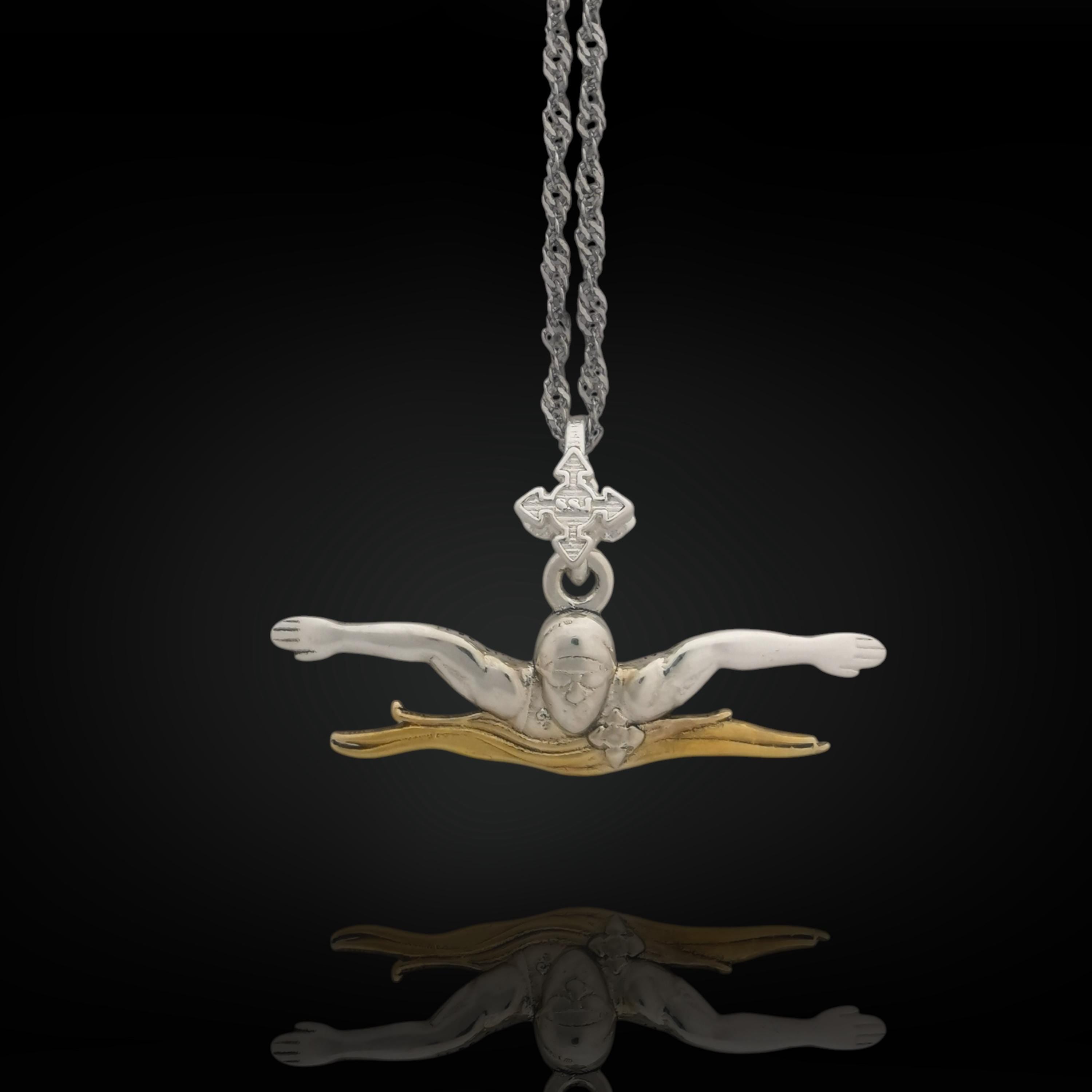 Two-tone butterfly swimming pendant handcrafted in solid 925 sterling silver with partial gold plating — a bold tribute to speed, motion, and the discipline of competitive swimming.

Featuring a male swimmer mid-butterfly stroke, this pendant captures precision and strength in every line. The gold-accented details enhance the figure&#39;s power and presence, creating a meaningful gift for swimmers, coaches, or fans of water sports and elegant design.