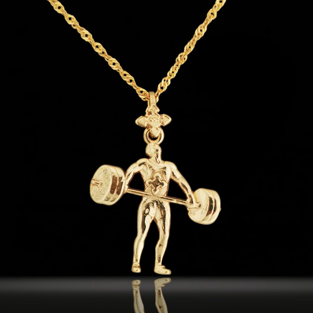 Gold-plated weightlifting necklace in 925 sterling silver – bold gym pendant made for strong-willed men who lift with passion. Designed for bodybuilders, coaches, and disciplined athletes, this piece combines elegance with raw power.

The handcrafted figure shows a male lifter mid-movement with a detailed barbell – a tribute to strength, endurance, and fitness goals. The rich gold-plated finish adds a modern yet classic edge, perfect for gifting or daily wear.