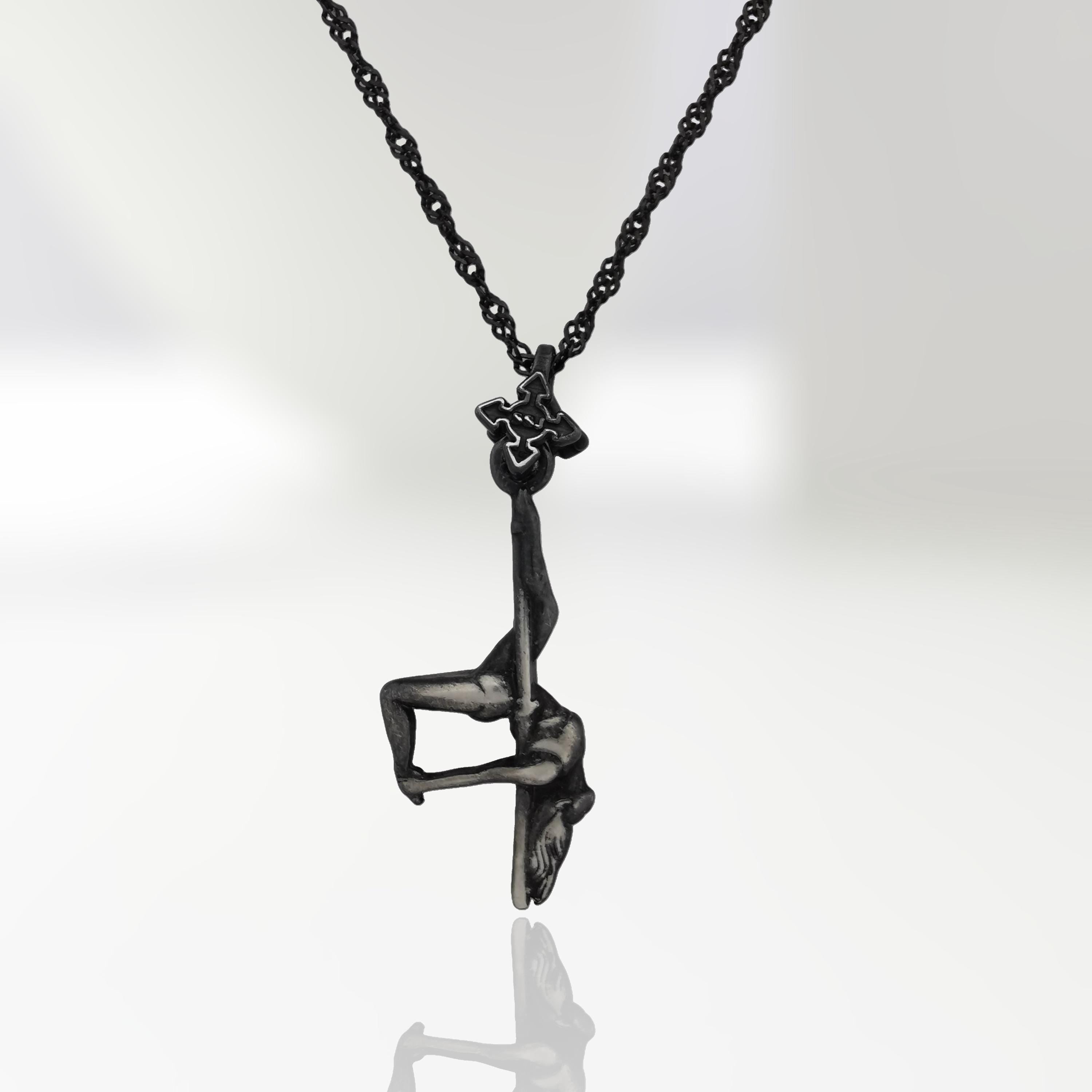 Vintage-style pole dance necklace in patinated 925 sterling silver — a timeless tribute to sensuality, grace, and the art of movement.

This handcrafted piece features a female pole dancer suspended mid-pose, captured in an expressive inverted form. The antique finish adds depth and character, enhancing every curve with classic elegance and bold artistry. A pendant for women who move with passion and leave a lasting impression.