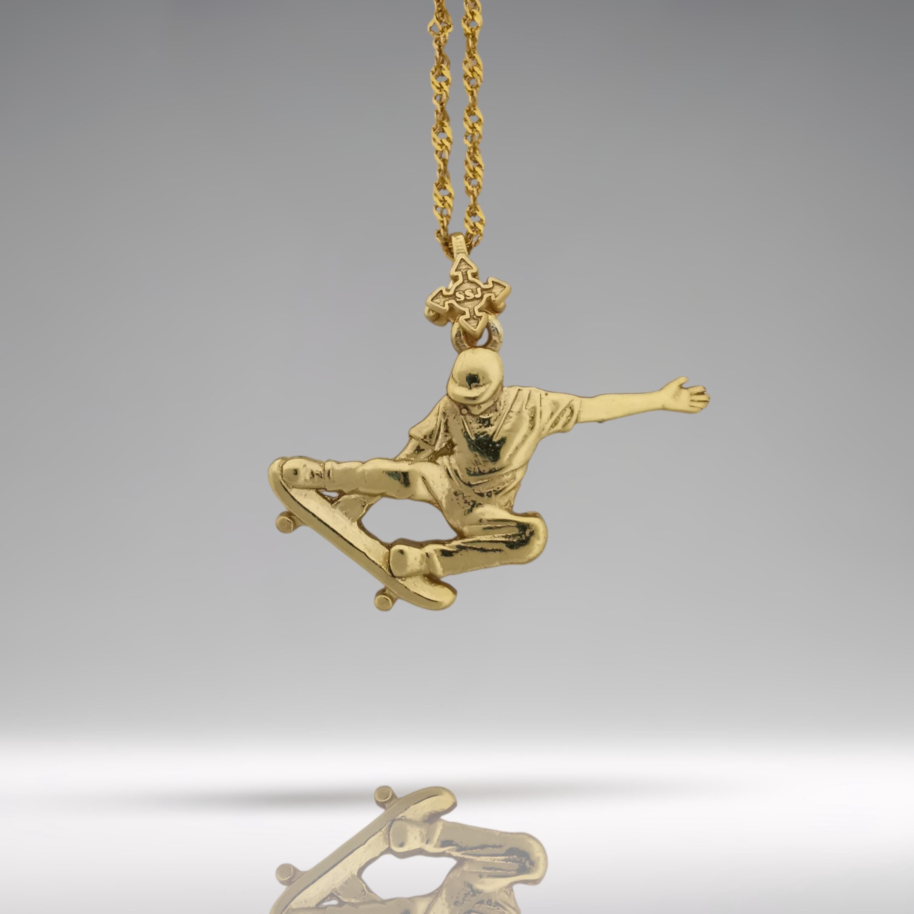 Gold skateboard necklace made from solid 925 sterling silver with a polished gold finish – a bold streetwear pendant for skaters, freestyle athletes, and men who ride with fearless energy. Designed for movement and impact, this handcrafted piece channels raw style and dynamic confidence.

Capturing a skateboarder mid-trick, it celebrates individuality, freedom, and the power of motion. Whether for everyday wear or standout moments, this pendant speaks the language of those who push limits.