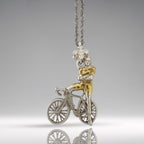 Two-tone cyclist necklace handcrafted from solid 925 sterling silver with partial gold plating — a modern and elegant pendant for men who live with energy, intention, and style.

This unique design features a proud rider standing beside his bicycle, arms confidently crossed. The subtle gold accents highlight the rider’s form and bike details, creating a bold contrast with the polished silver. It’s a wearable tribute to strength, focus, and personal discipline