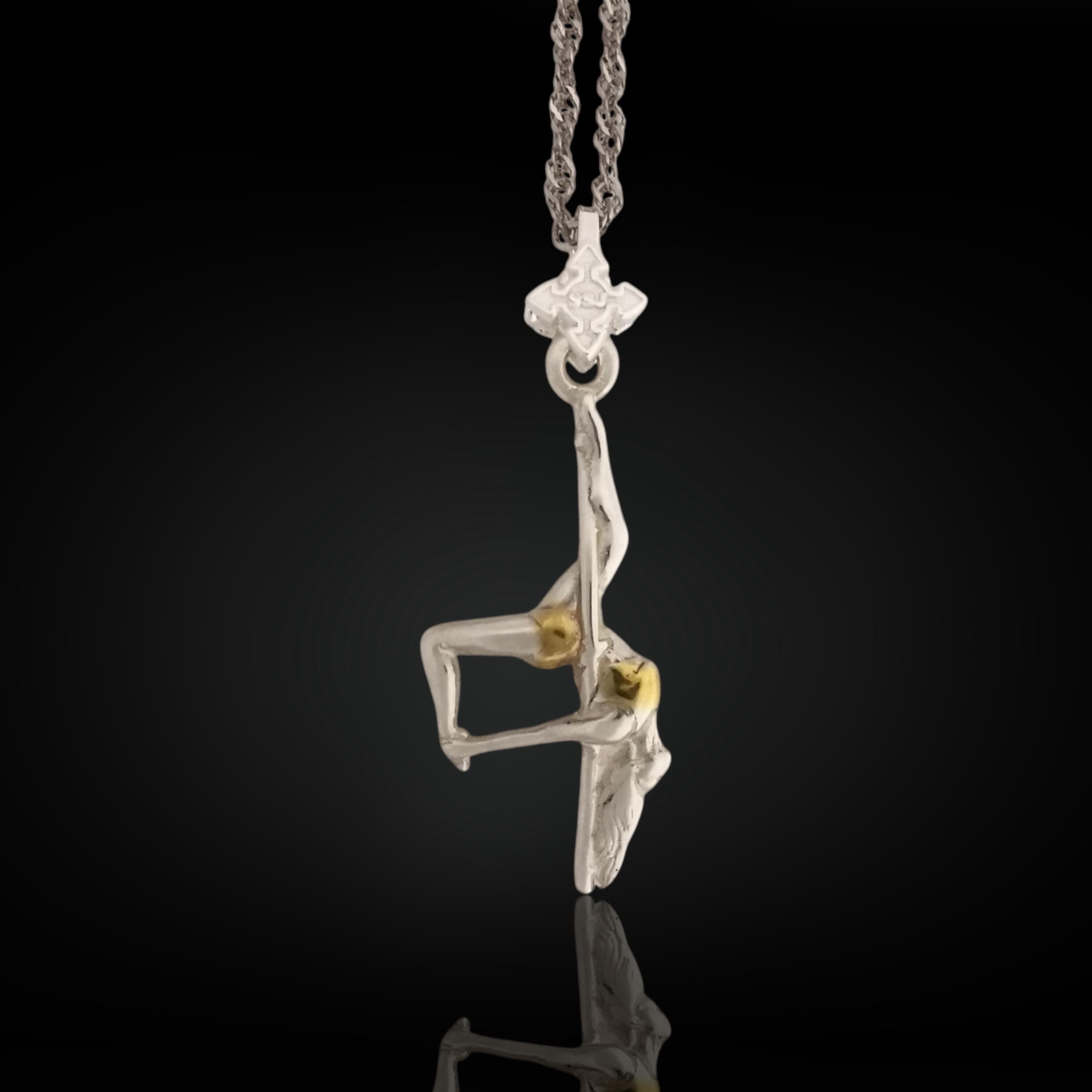 Two-tone pole dance necklace handcrafted in solid 925 sterling silver with elegant gold detailing — a refined and sensual pendant celebrating feminine strength and expressive beauty.

This design captures a dancer mid-performance, suspended upside down in an artistic pose. The contrast between silver and gold enhances the curves, grace, and emotion of the piece. A wearable tribute to confidence, bold movement, and the freedom of self-expression — on the stage or in everyday life.