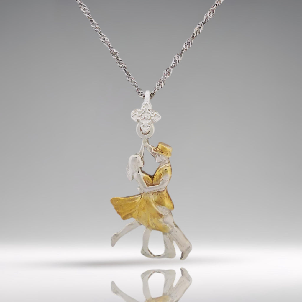 Looking for a romantic gift for her? This elegant two-tone tango pendant blends polished 925 sterling silver with graceful gold-plated accents — a tribute to the passion, precision, and connection found in Latin and ballroom dance.

The design features a dancing couple in fluid motion, symbolizing both the intensity of tango and the delicate harmony between strength and grace. The dual-metal finish adds timeless beauty and makes this piece