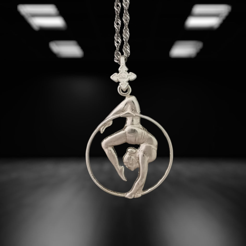 Classic aerial hoop necklace handcrafted from solid 925 sterling silver — a delicate and striking pendant that honors the elegance of aerial performance and the beauty of the human form in motion.

The design features a female aerialist suspended mid-flow, captured in an expressive pose that radiates balance, flexibility, and femininity. A meaningful piece for those drawn to dance, circus art, or the poetic lines of aerial movement. Wearable art with strength and grace.