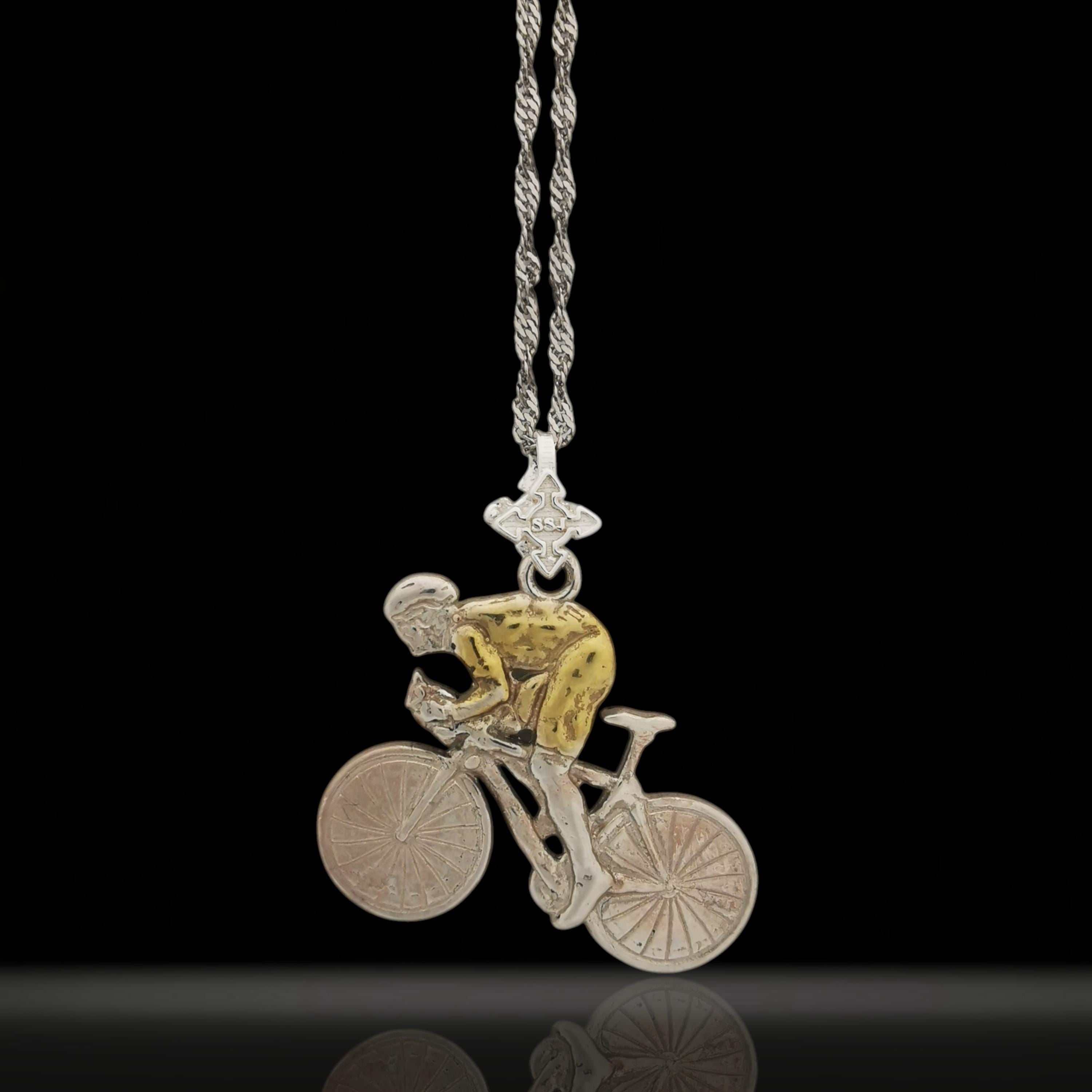 Two-tone cycling pendant handcrafted in solid 925 sterling silver with partial gold plating — a striking piece for men who ride with purpose and pride. The contrast of silver and gold detail highlights movement, determination, and endurance.

Depicting a cyclist in action, this dynamic design honors the passion behind every pedal — whether on the road, in competition, or through personal milestones. A unique gift for men who live for the ride and wear their drive with style.