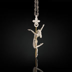 Two-tone pole dance necklace crafted in solid 925 sterling silver with elegant gold plating – a refined and sensual pendant celebrating the beauty of feminine movement.

The design features a graceful woman wrapped around the pole in an expressive pose. The silver-and-gold contrast highlights the curves, energy, and elegance of the performance. A tribute to confidence, desire, and the freedom of self-expression – whether on stage or in life.