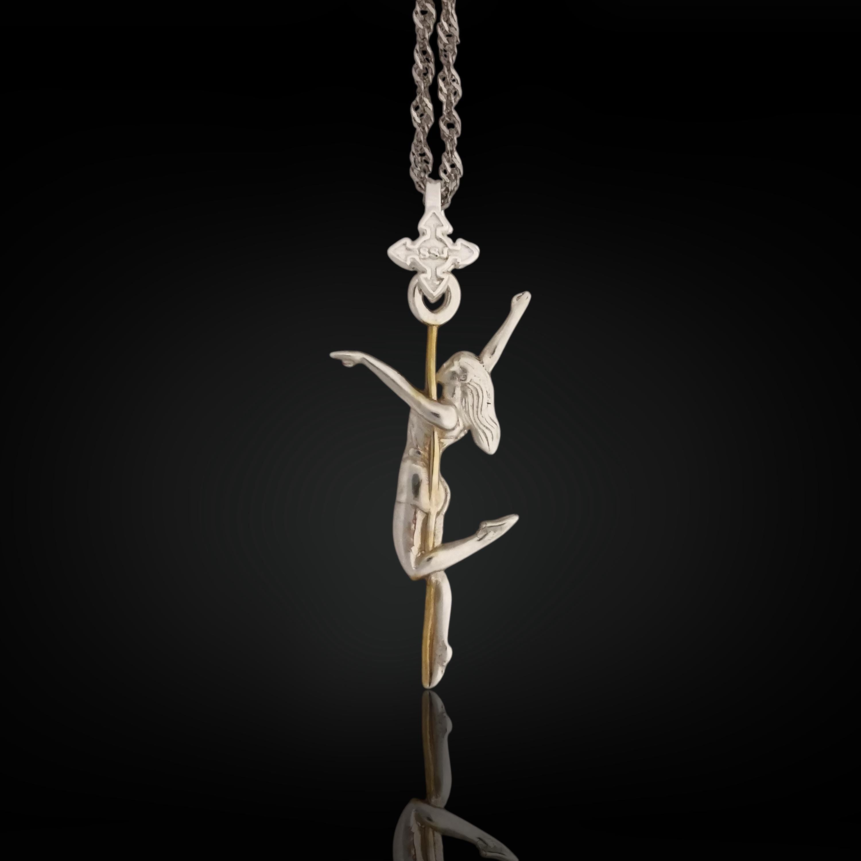 Two-tone pole dance necklace crafted in solid 925 sterling silver with elegant gold plating – a refined and sensual pendant celebrating the beauty of feminine movement.

The design features a graceful woman wrapped around the pole in an expressive pose. The silver-and-gold contrast highlights the curves, energy, and elegance of the performance. A tribute to confidence, desire, and the freedom of self-expression – whether on stage or in life.