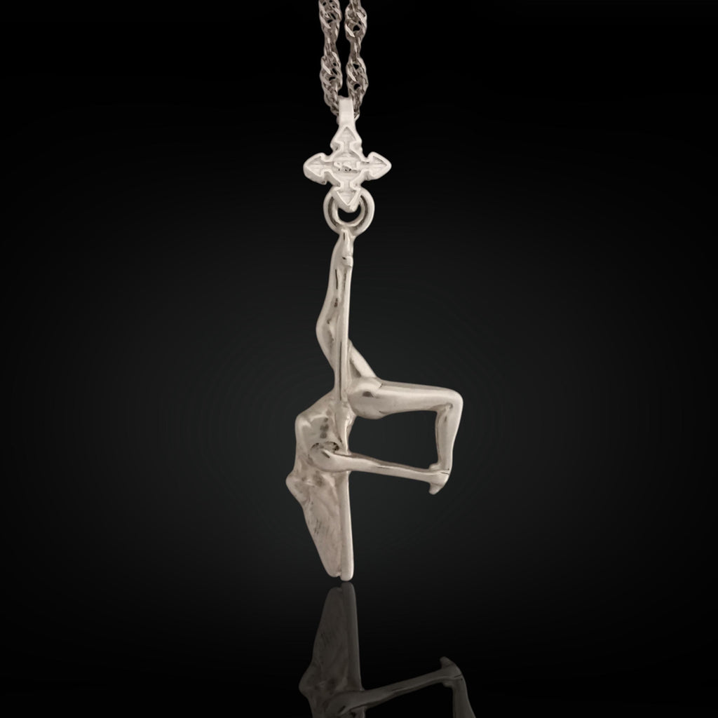 Pole dance pendant handcrafted in solid 925 sterling silver – a radiant and artistic tribute to feminine beauty, strength, and fluid movement.

This sculptural piece captures a pole dancer mid-performance, posed in a dramatic inverted position with expressive detail. The polished silver enhances the flowing curves and emotional intensity of the figure, turning motion into wearable art. A statement of confidence, seduction, and unapologetic expression.
