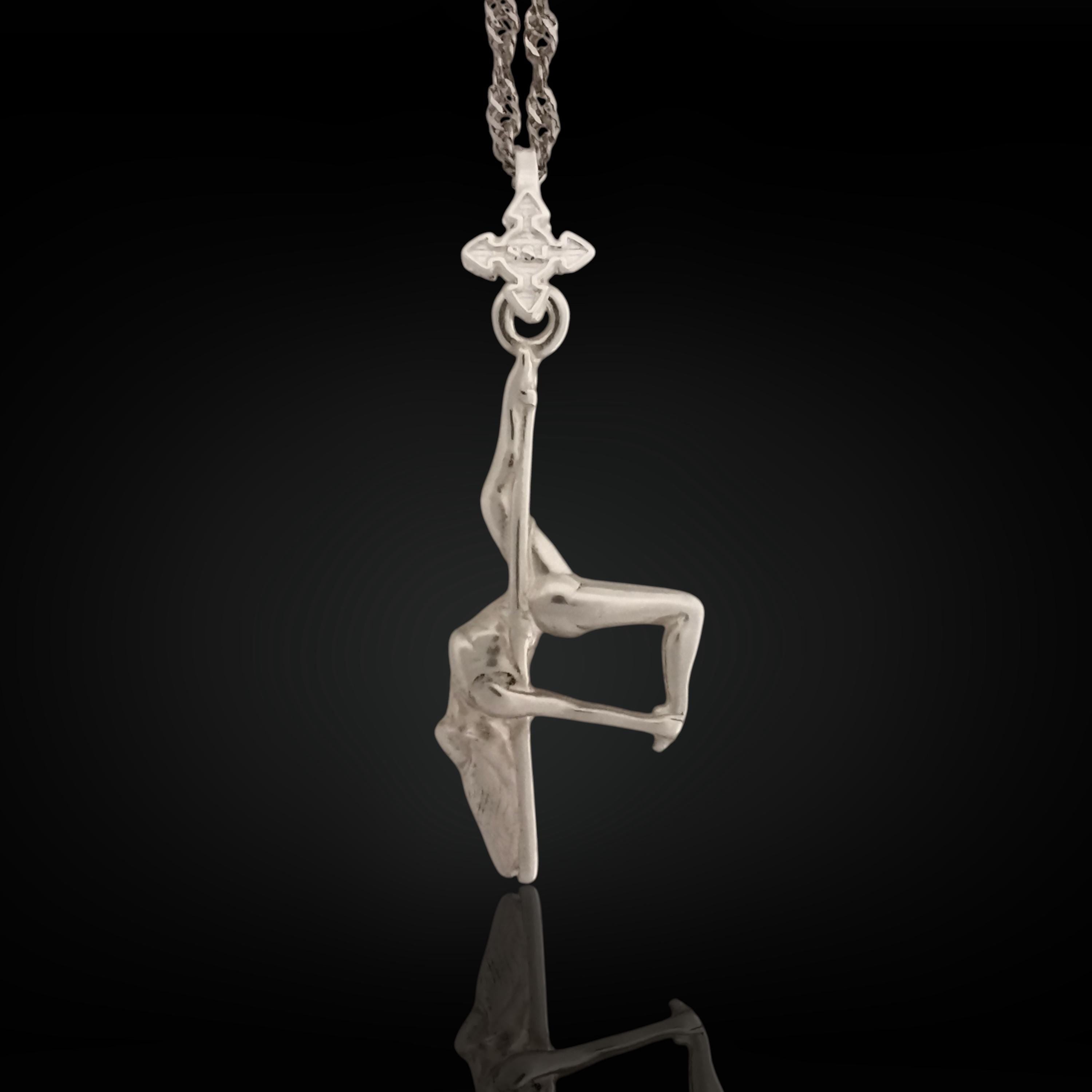 Pole dance pendant handcrafted in solid 925 sterling silver – a radiant and artistic tribute to feminine beauty, strength, and fluid movement.

This sculptural piece captures a pole dancer mid-performance, posed in a dramatic inverted position with expressive detail. The polished silver enhances the flowing curves and emotional intensity of the figure, turning motion into wearable art. A statement of confidence, seduction, and unapologetic expression.