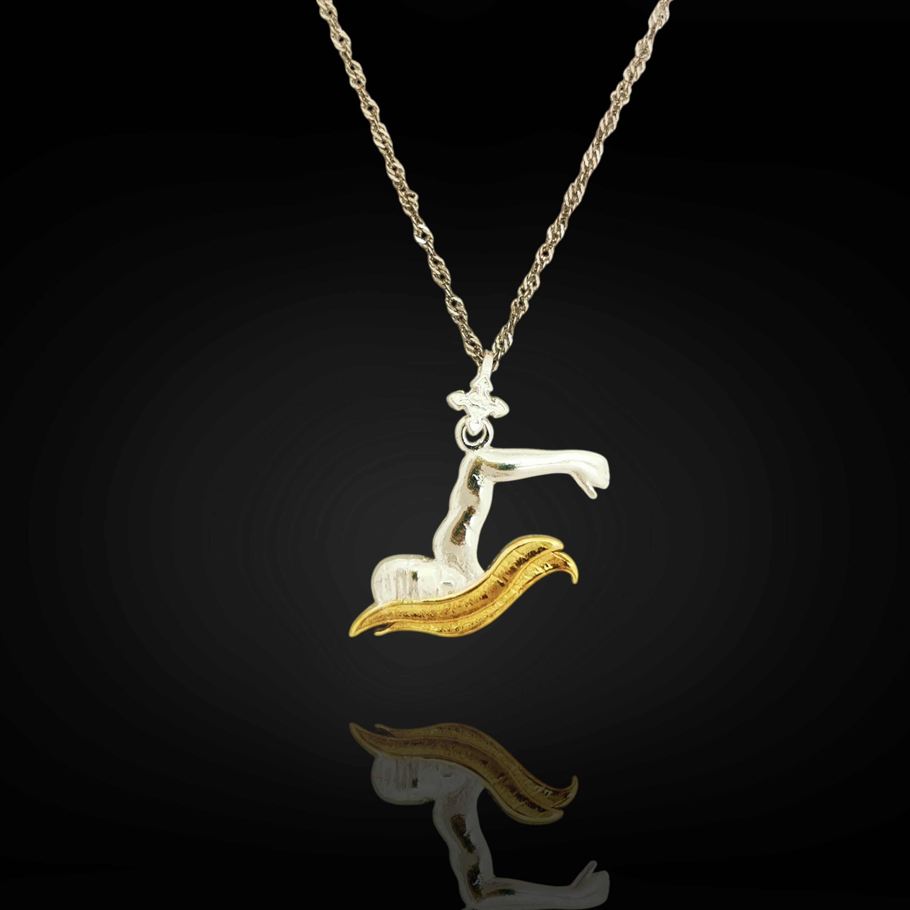 Two-tone swimmer pendant in solid 925 sterling silver with partial gold plating — a standout piece for men and teen boys who live to perform in the pool.

The pendant features a swimmer mid-breaststroke, combining clean silver lines with subtle gold detail for contrast and style. Designed for boys and men who pursue strength, discipline, and self-mastery. A unique gift for team members, coaches, or personal milestones in training and competition.