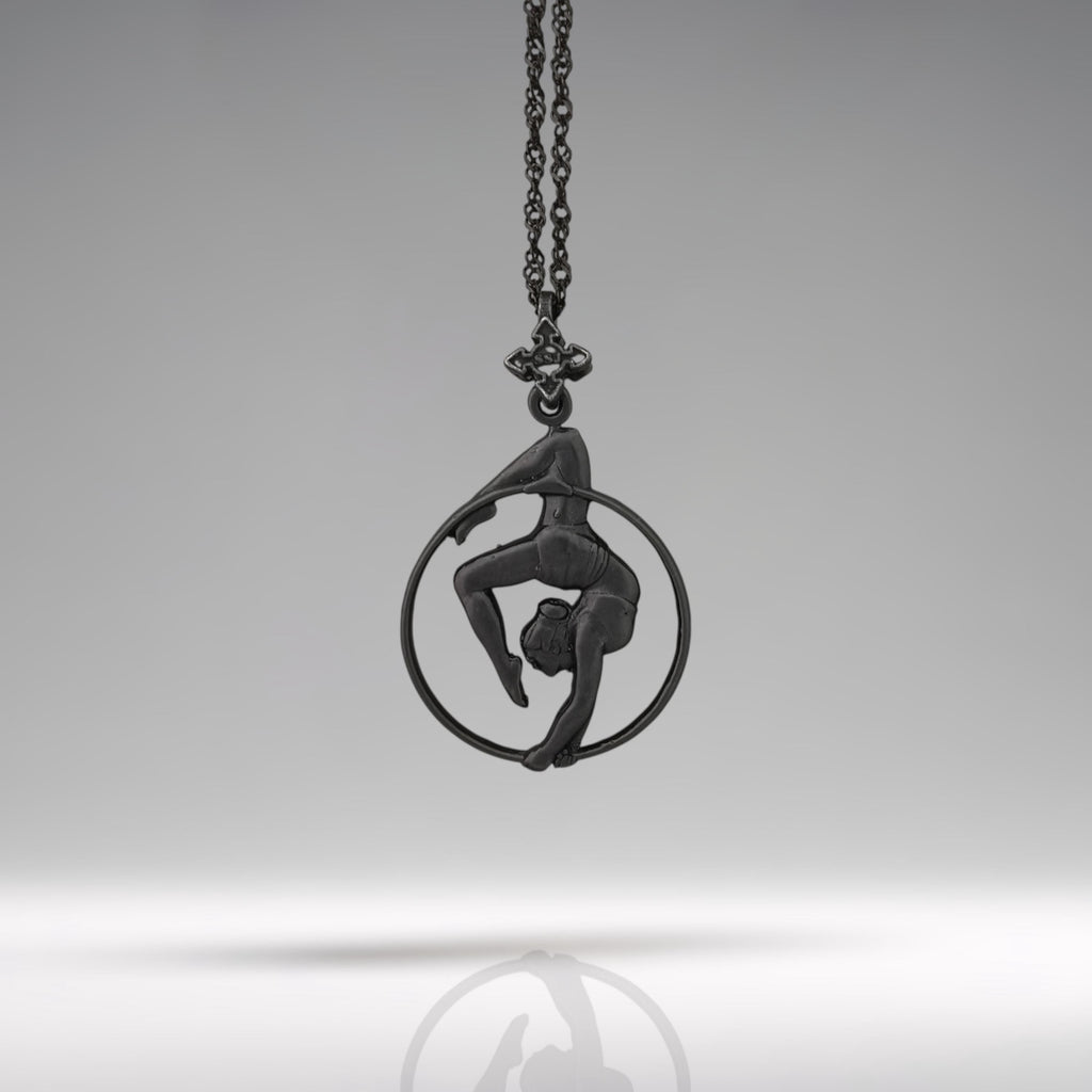 Black oxidized aerial hoop necklace crafted from solid 925 sterling silver — a dramatic and empowering pendant that celebrates aerial artistry, fluid motion, and fearless femininity.

This handcrafted piece features a woman in a graceful inverted pose within the hoop, capturing the strength, elegance, and poise of aerial dance. The deep matte black finish adds mystery and edge, transforming it into a bold symbol of control, beauty, and physical expression. Ideal for women who rise,