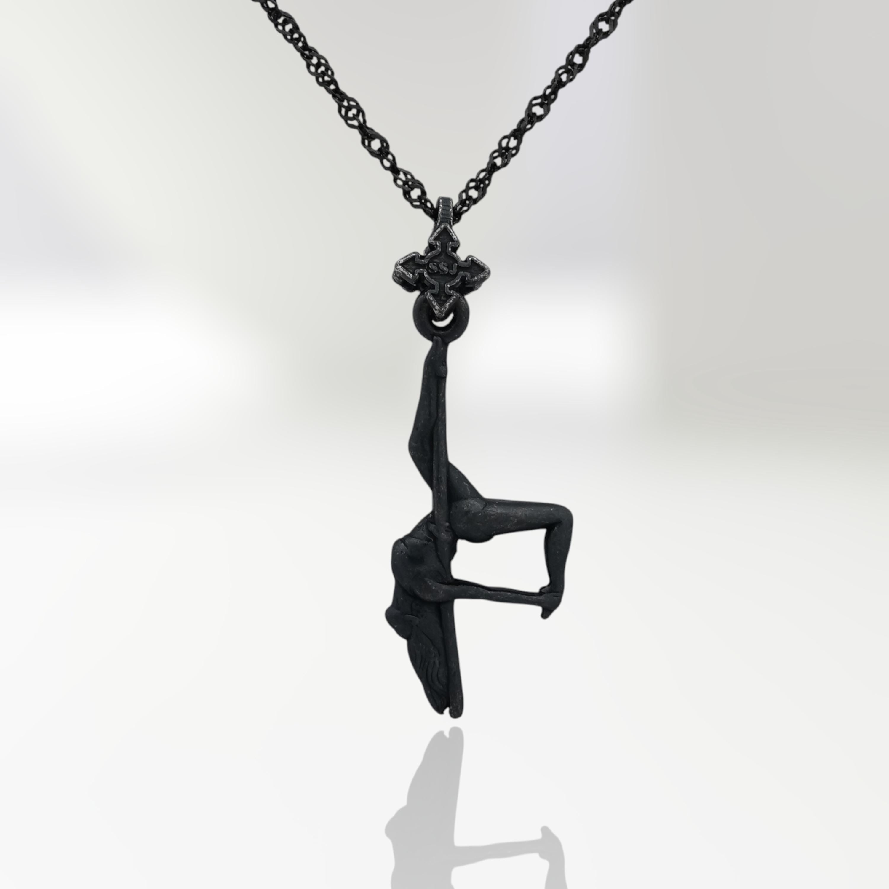 Black oxidized pole dance pendant in 925 sterling silver — a dark, expressive piece that radiates sensuality, mystery, and feminine confidence.

This handcrafted design captures a pole dancer mid-performance in an inverted pose, full of raw energy and erotic tension. The matte black finish adds a bold urban edge to her graceful curves, turning every line into a statement. A celebration of power, elegance, and fearless femininity — perfect for those who own their movement and identity.